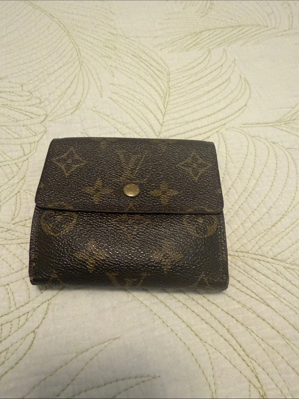 Louis Vuitton trifold snap wallet. Authentication provided.